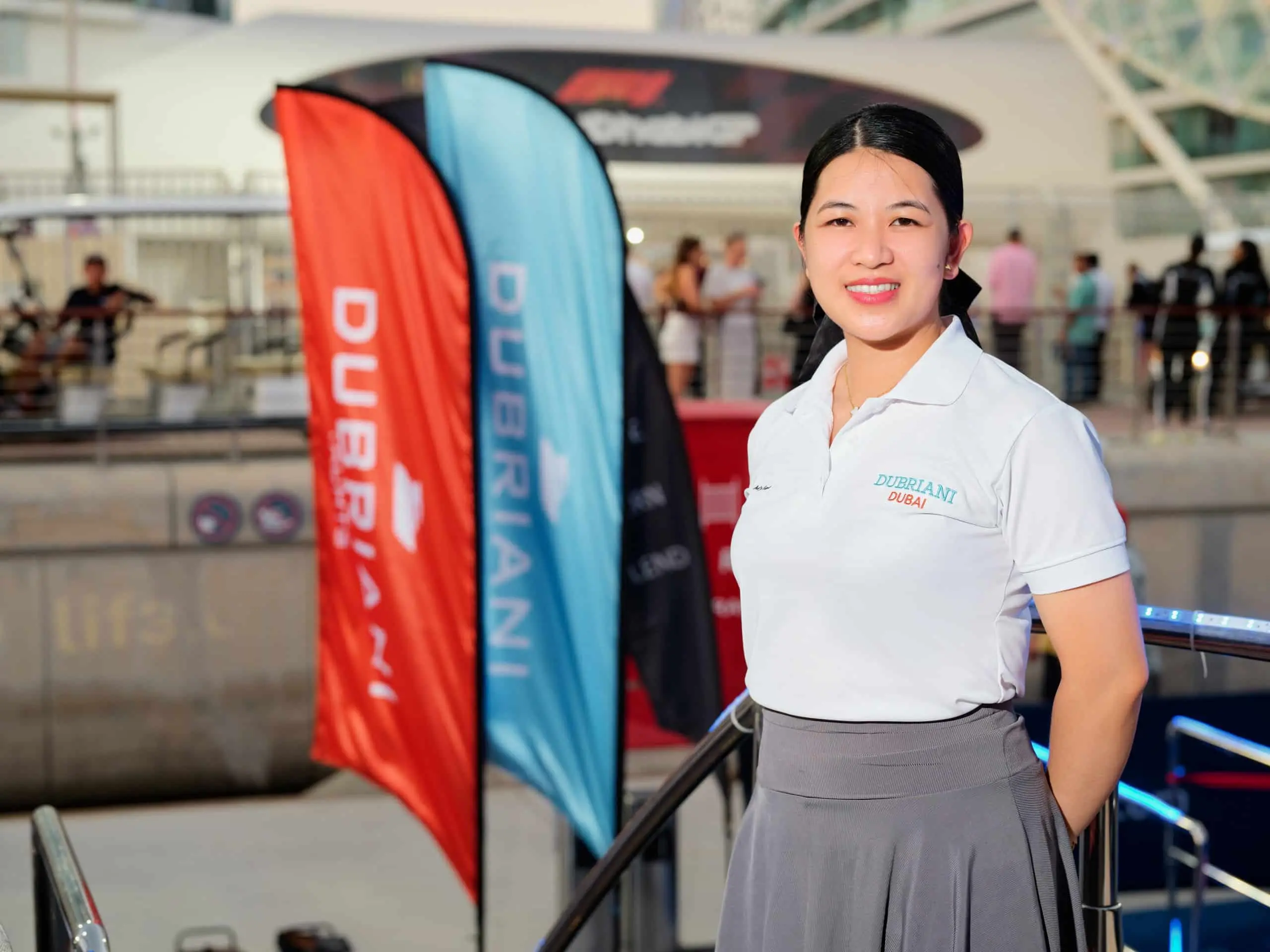 Event hostess welcoming guests during Abu Dhabi Formula 1 yacht hospitality experience