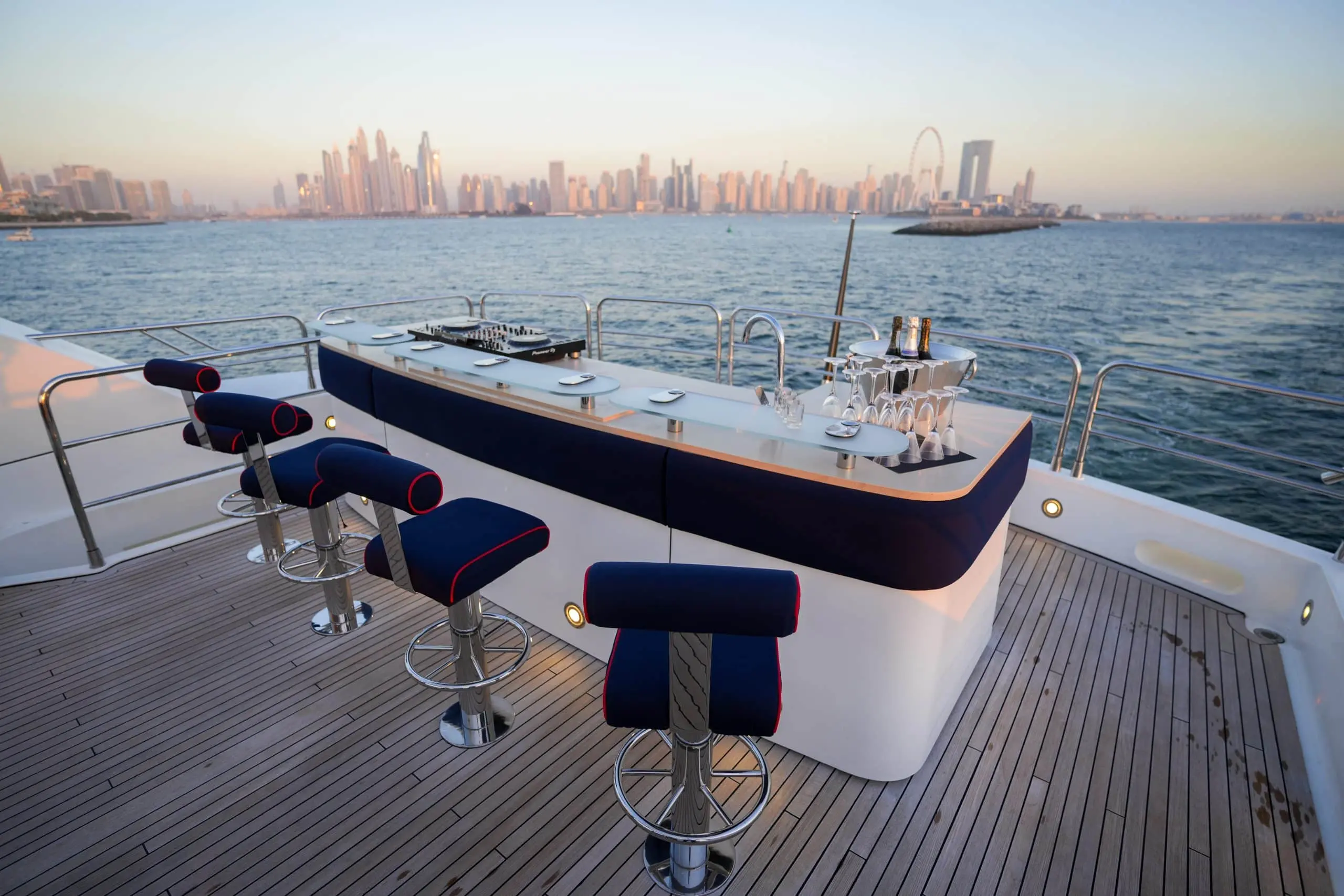 Foredeck lounge seating on Sunseeker 131 yacht with Dubai skyline view