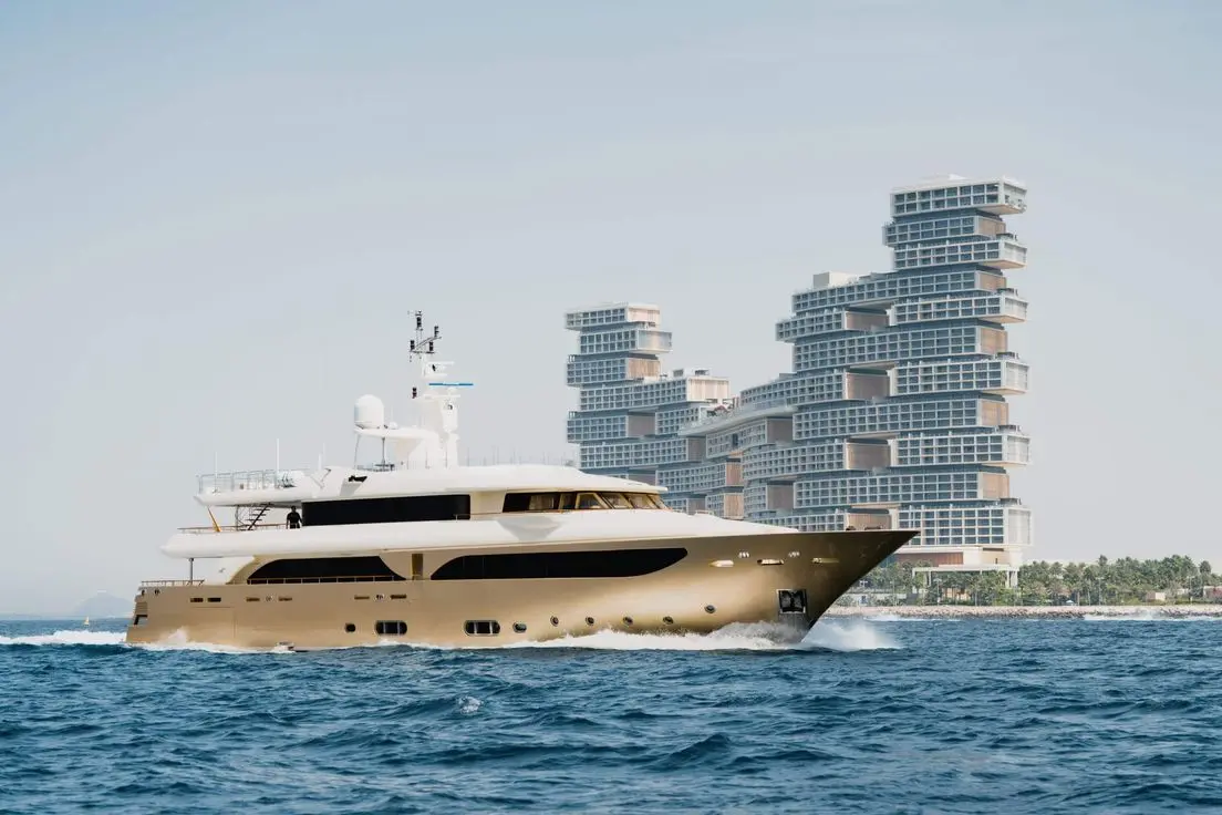 MILA 141 superyacht cruising past luxury waterfront residences in Abu Dhabi
