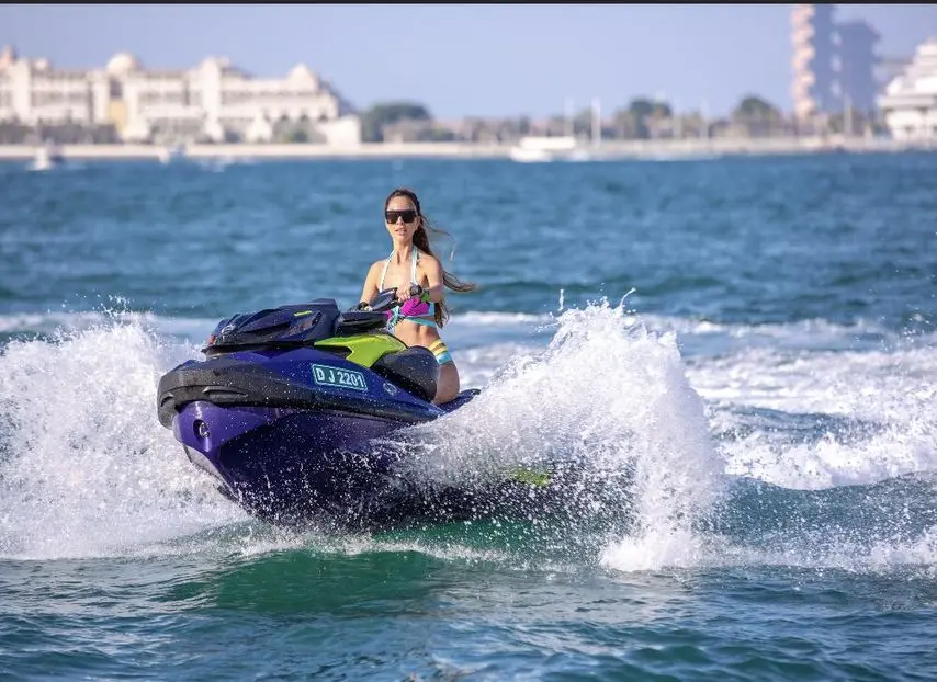 person riding jet ski during luxury yacht watersports activity