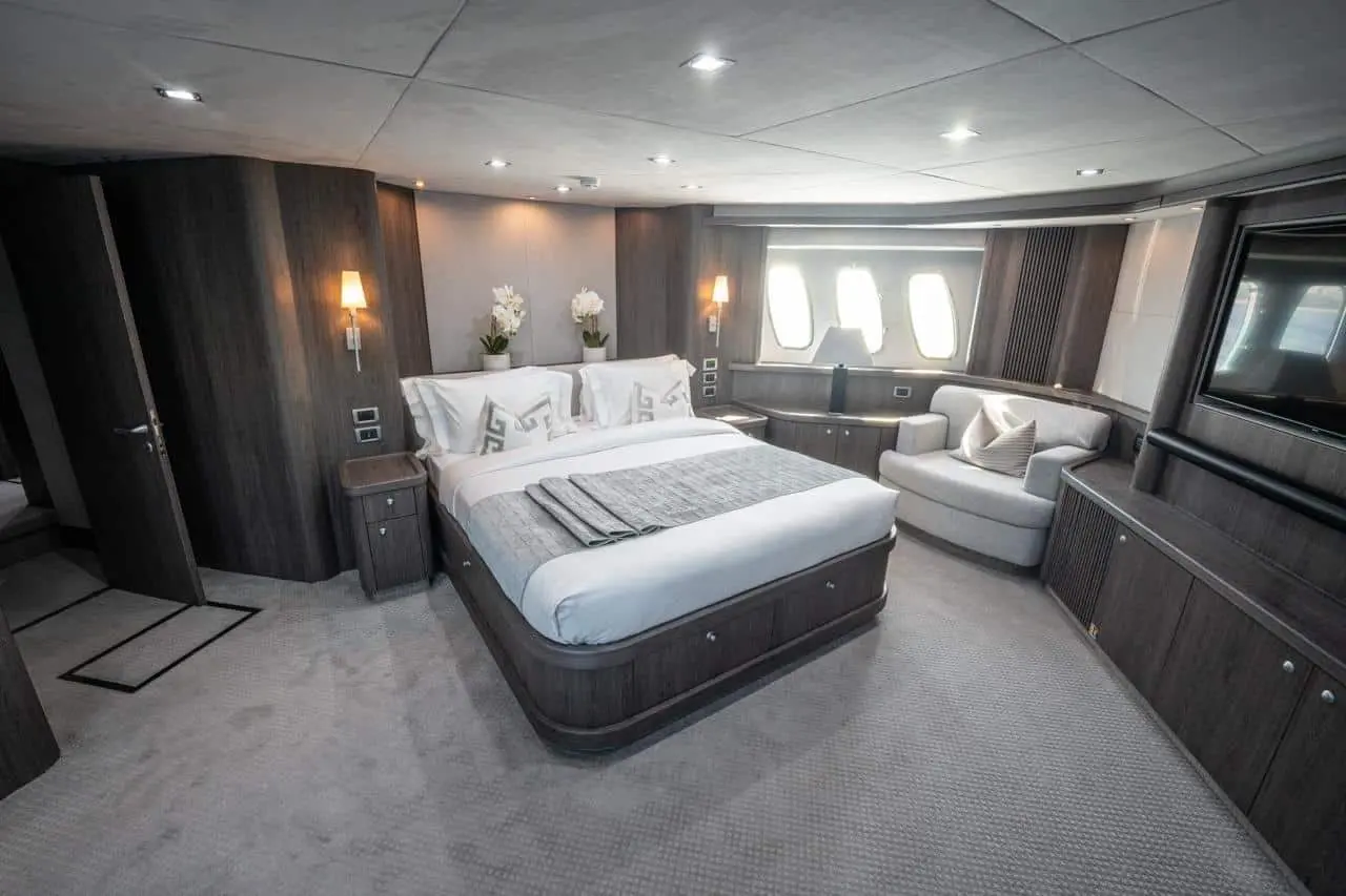 Sunseeker 82 Yacht master cabin with sofa and warm lighting