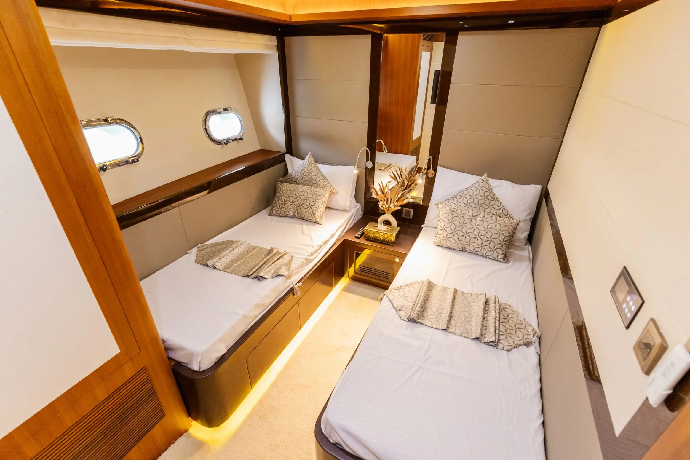 Cante 97 yacht guest bedroom with twin beds and wooden cabinetry