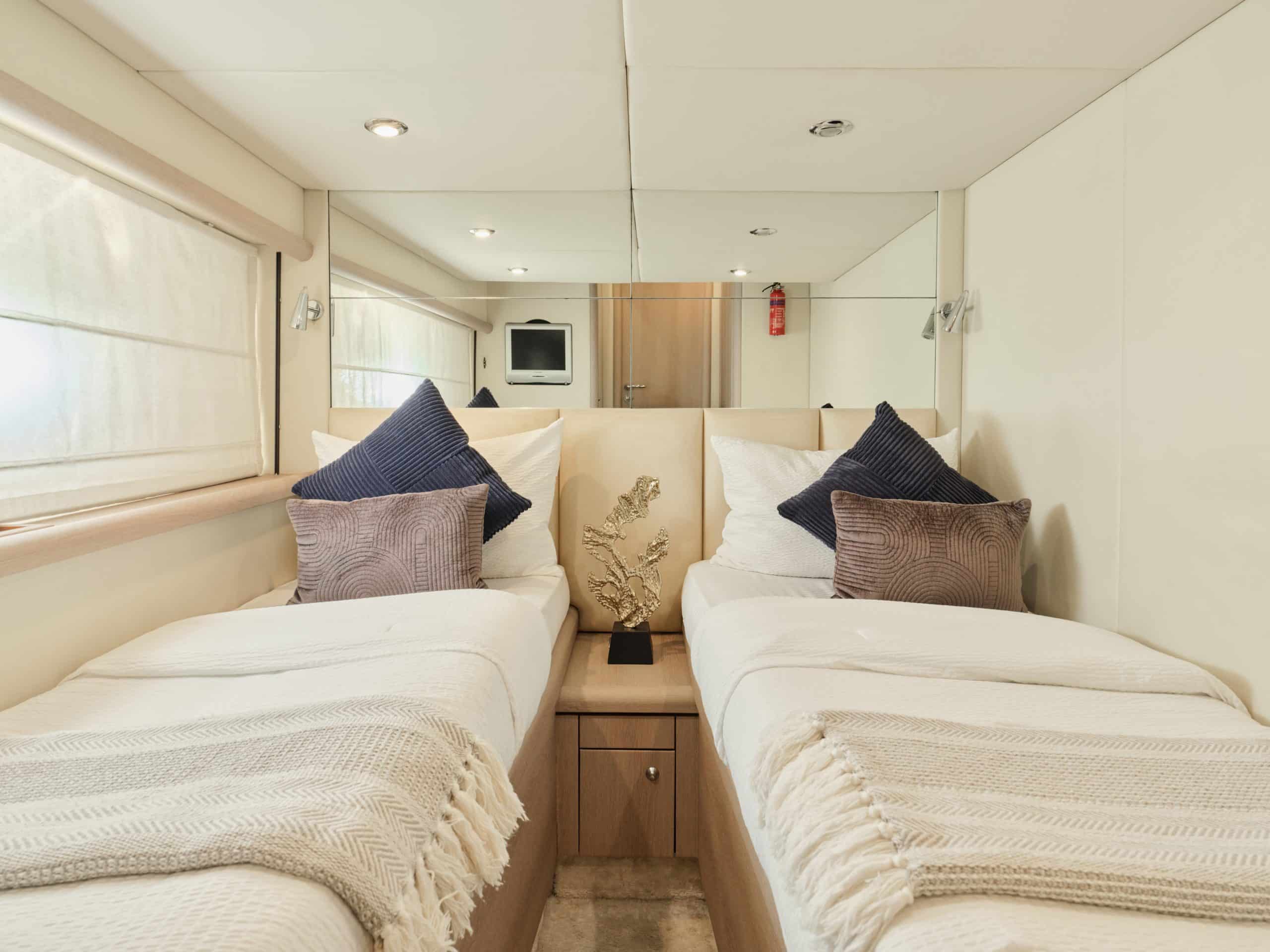 Sunseeker Satoshi 70 twin guest cabin with two single beds and soft lighting