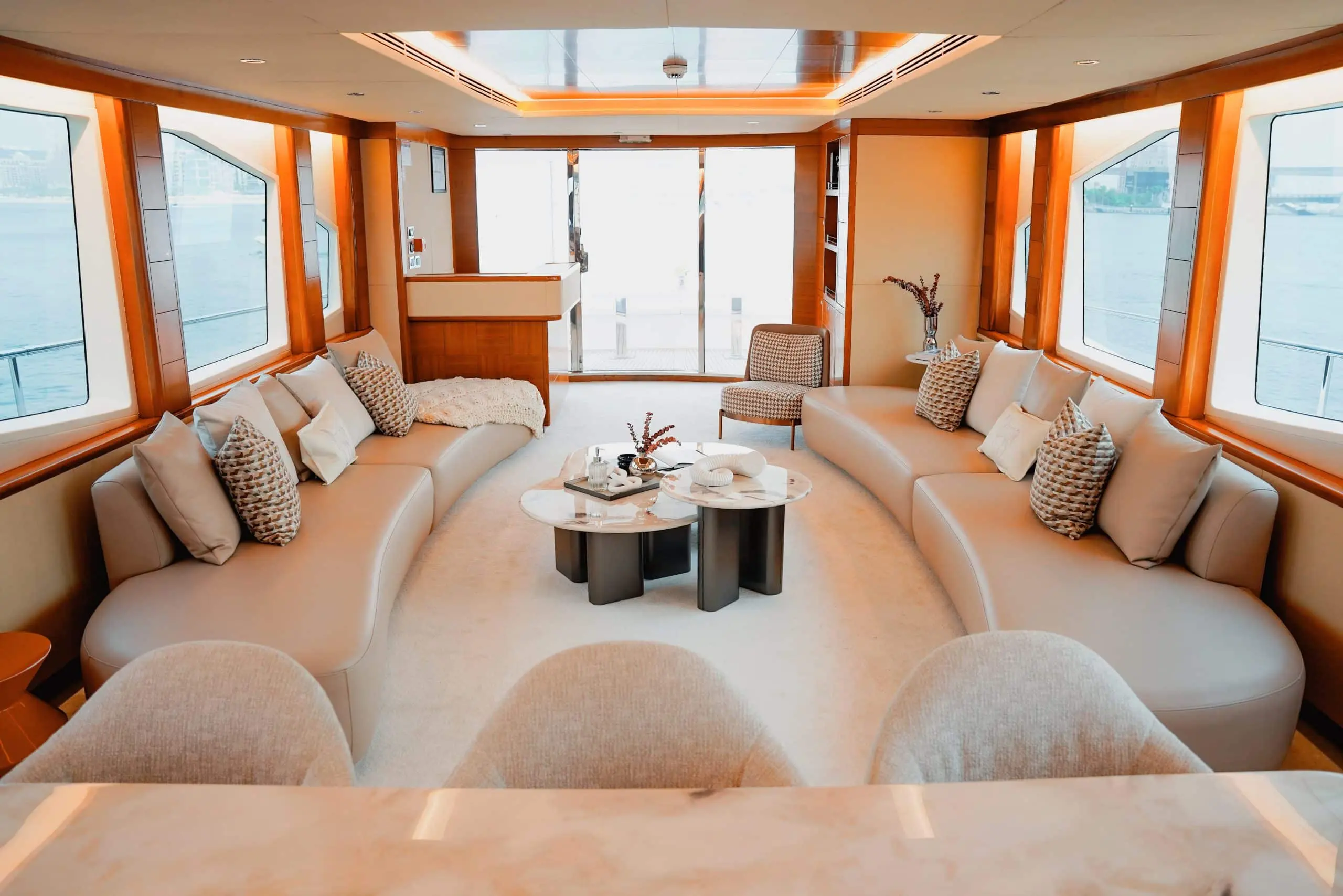 Spacious main salon lounge on Luna 101 yacht with panoramic windows at Yas Marina