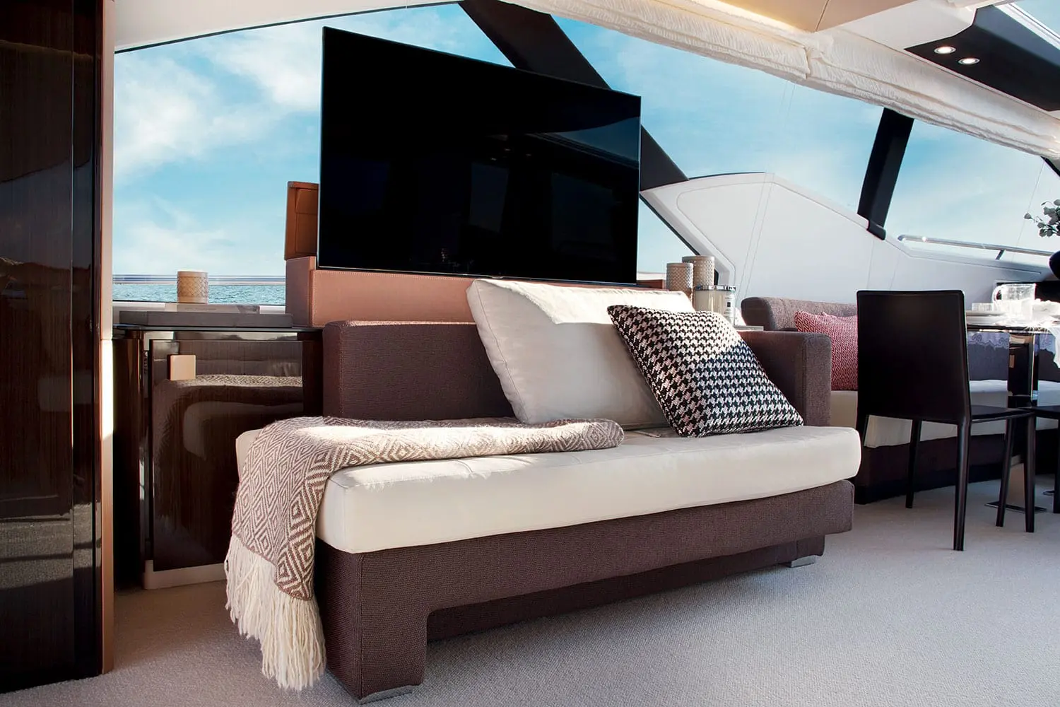 Azimut 77S saloon sofa with television raised — shipyard photo
