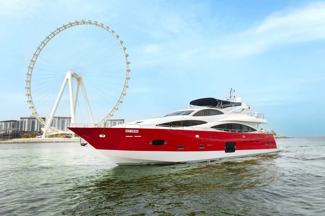 Asya 110 red hull yacht cruising near Ain Dubai observation wheel