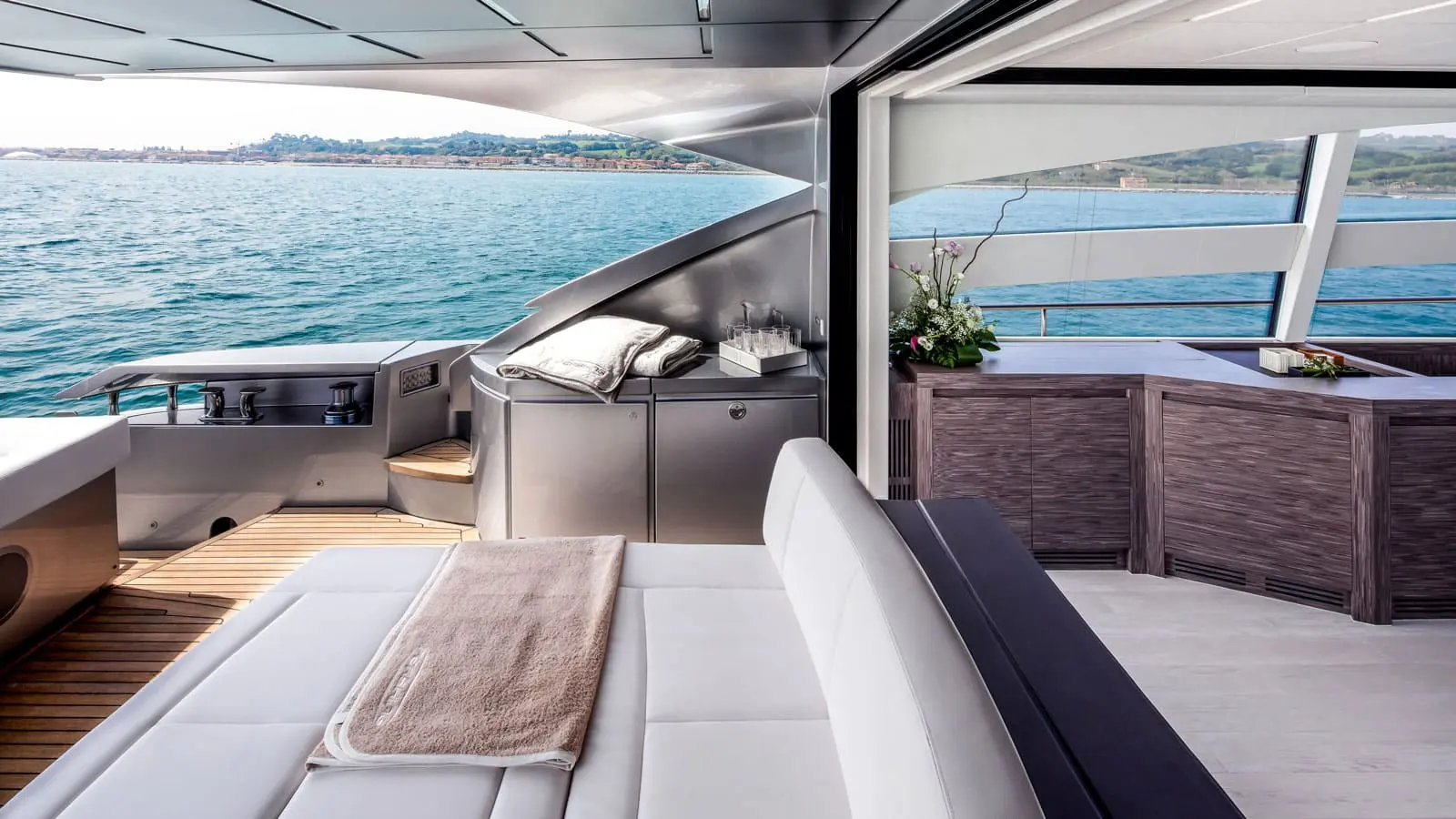 Pershing 82 aft cockpit sunpad and wet bar, shipyard press photo