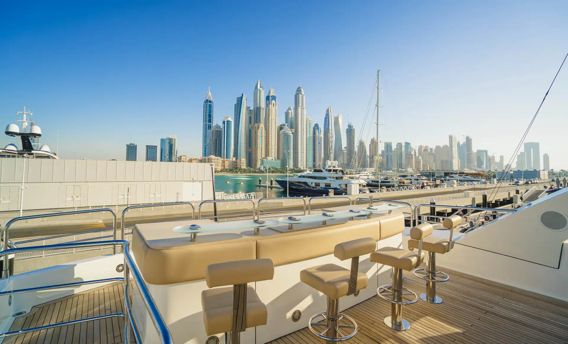 Sunseeker 131 yacht upper deck dining area with Dubai skyline view