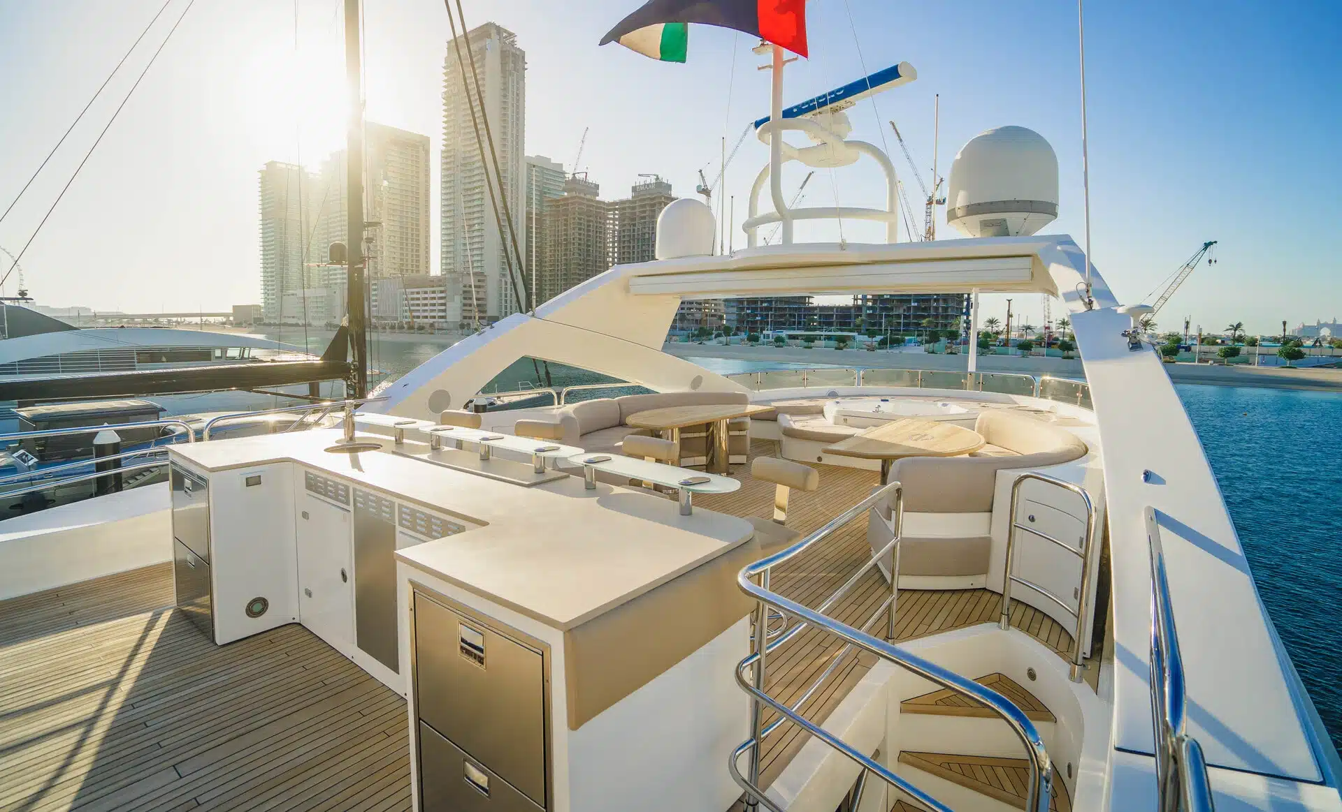 Outdoor bar and lounge seating on Sunseeker 131 superyacht with city skyline backdrop