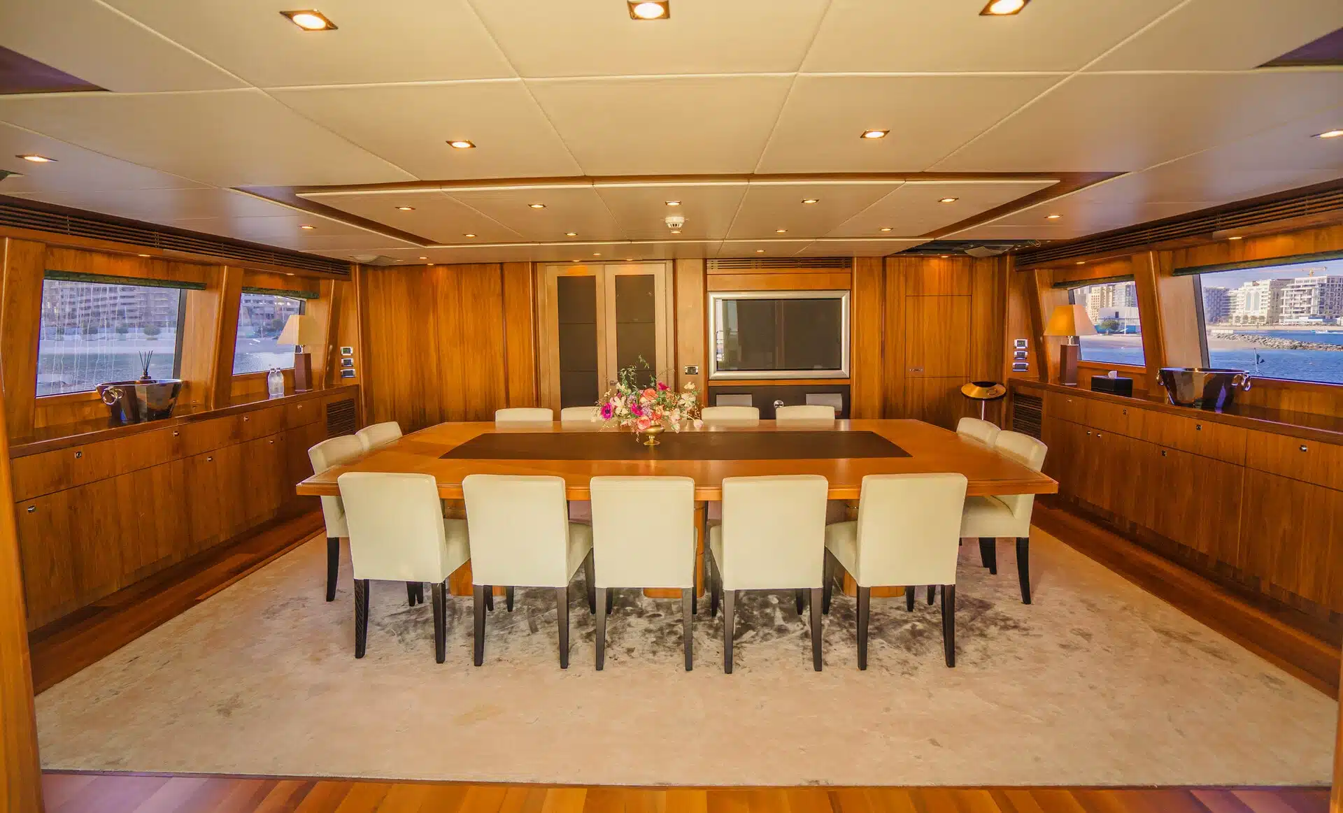 Formal dining room on Sunseeker 131 superyacht with long table and luxury seating