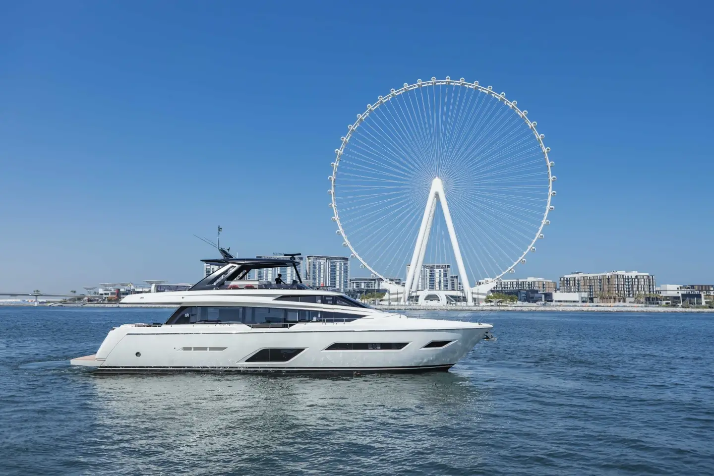 Ferretti 780 cruising in profile with Ain Dubai on the horizon