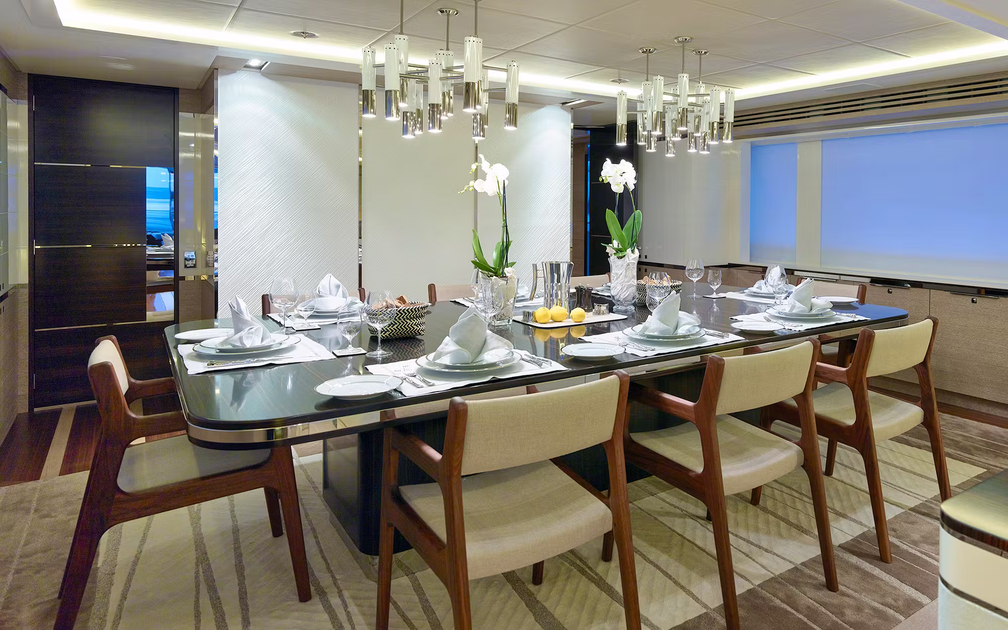 Refined indoor dining table setup on Sofiya 153 yacht