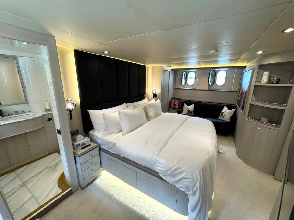Azimut 100 Jumbo master cabin in wide view with portholes