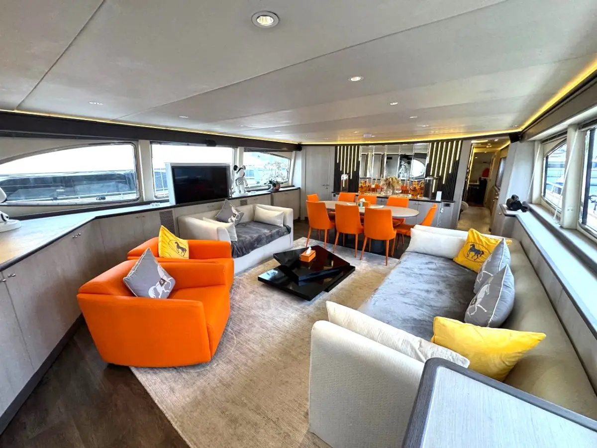 Azimut 100 Jumbo saloon with orange armchairs and grey sofa