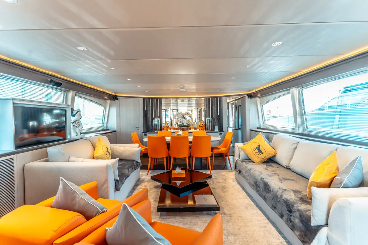 Azimut 100 Jumbo main saloon panorama with orange dining chairs