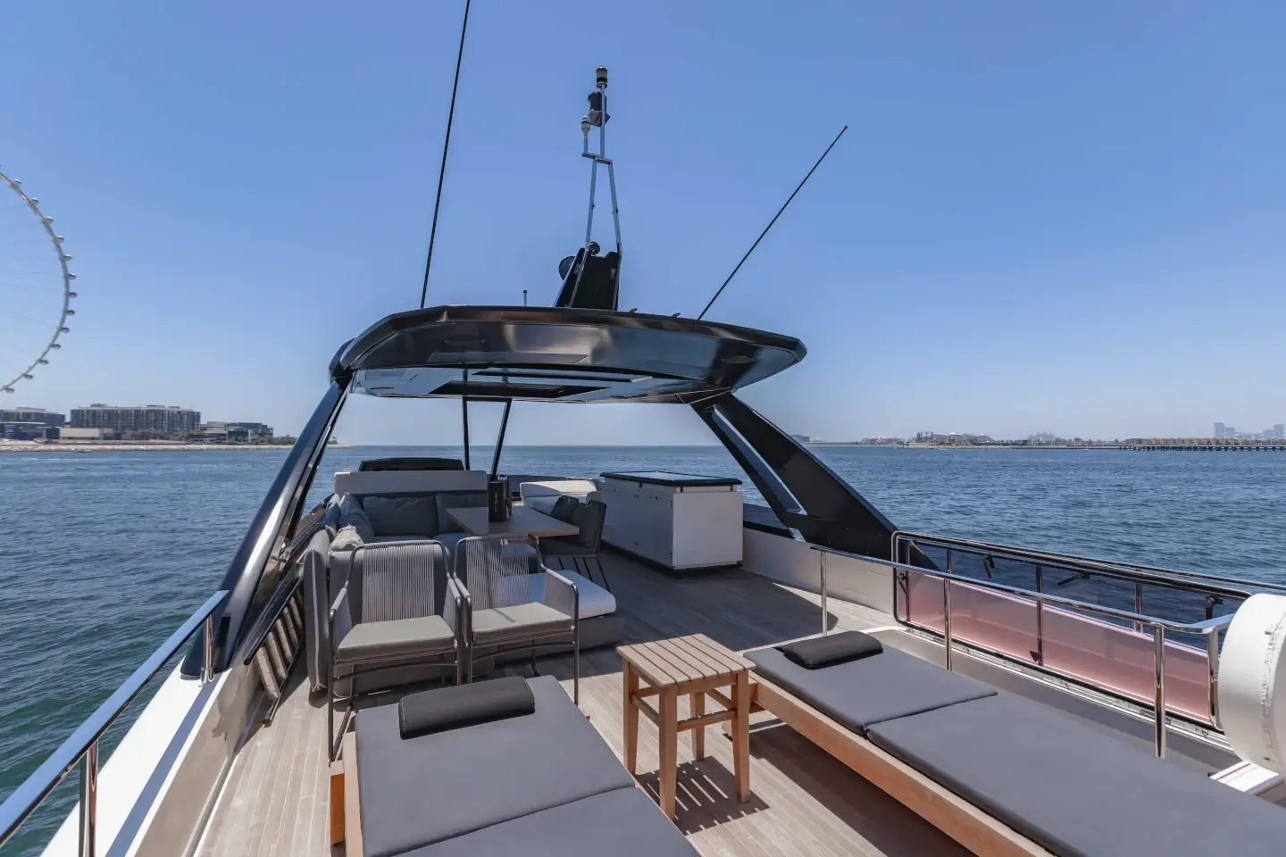 Ferretti 780 flybridge aft lounge with sun pads and teak deck