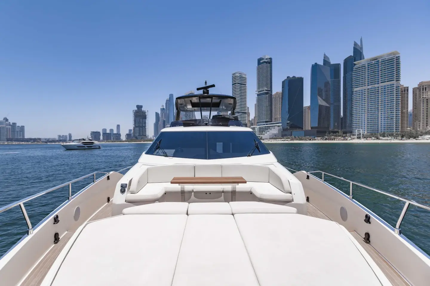 Ferretti 780 foredeck sun pad and bow seating with the Dubai Marina skyline