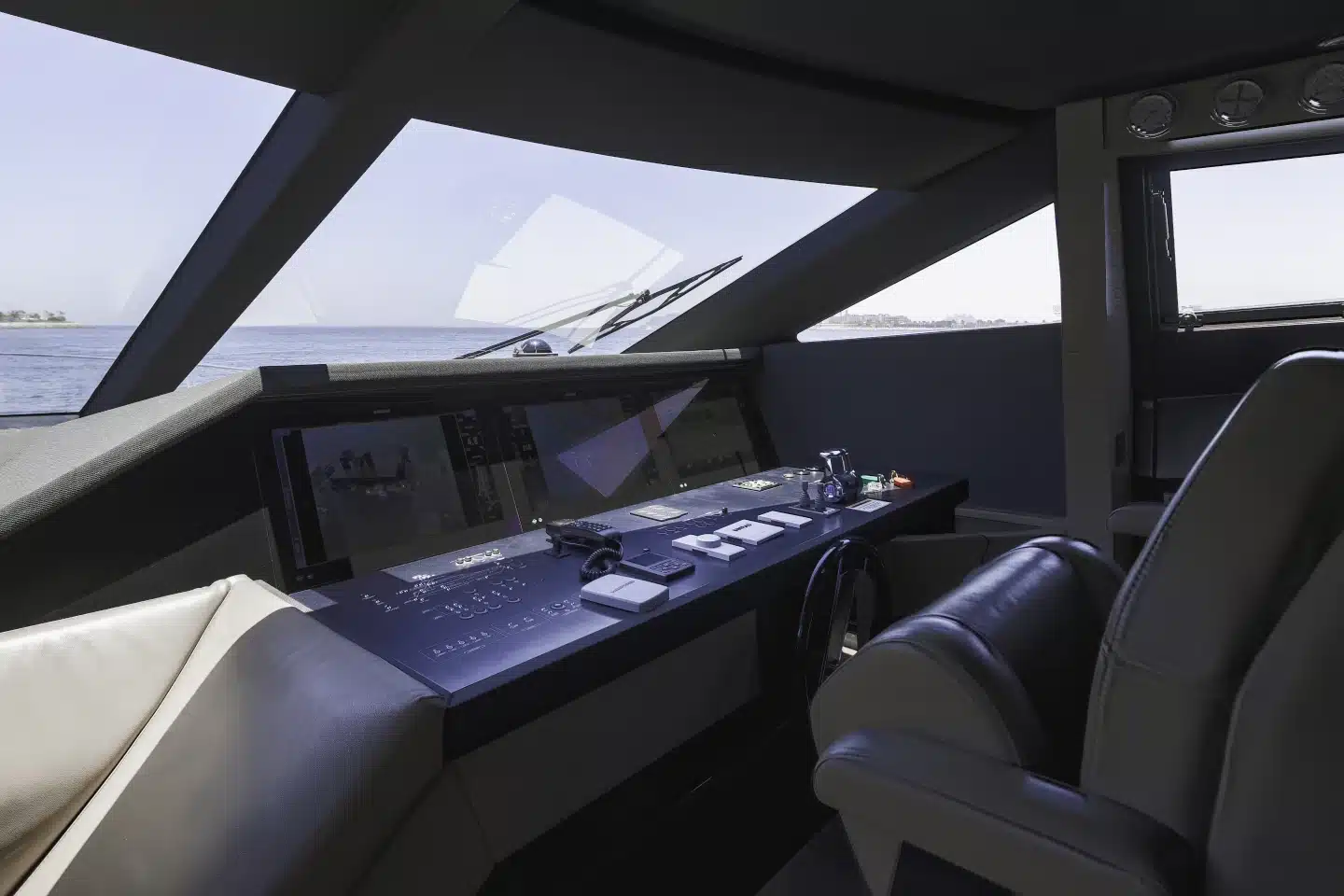 Ferretti 780 lower helm station with wraparound windscreen and displays