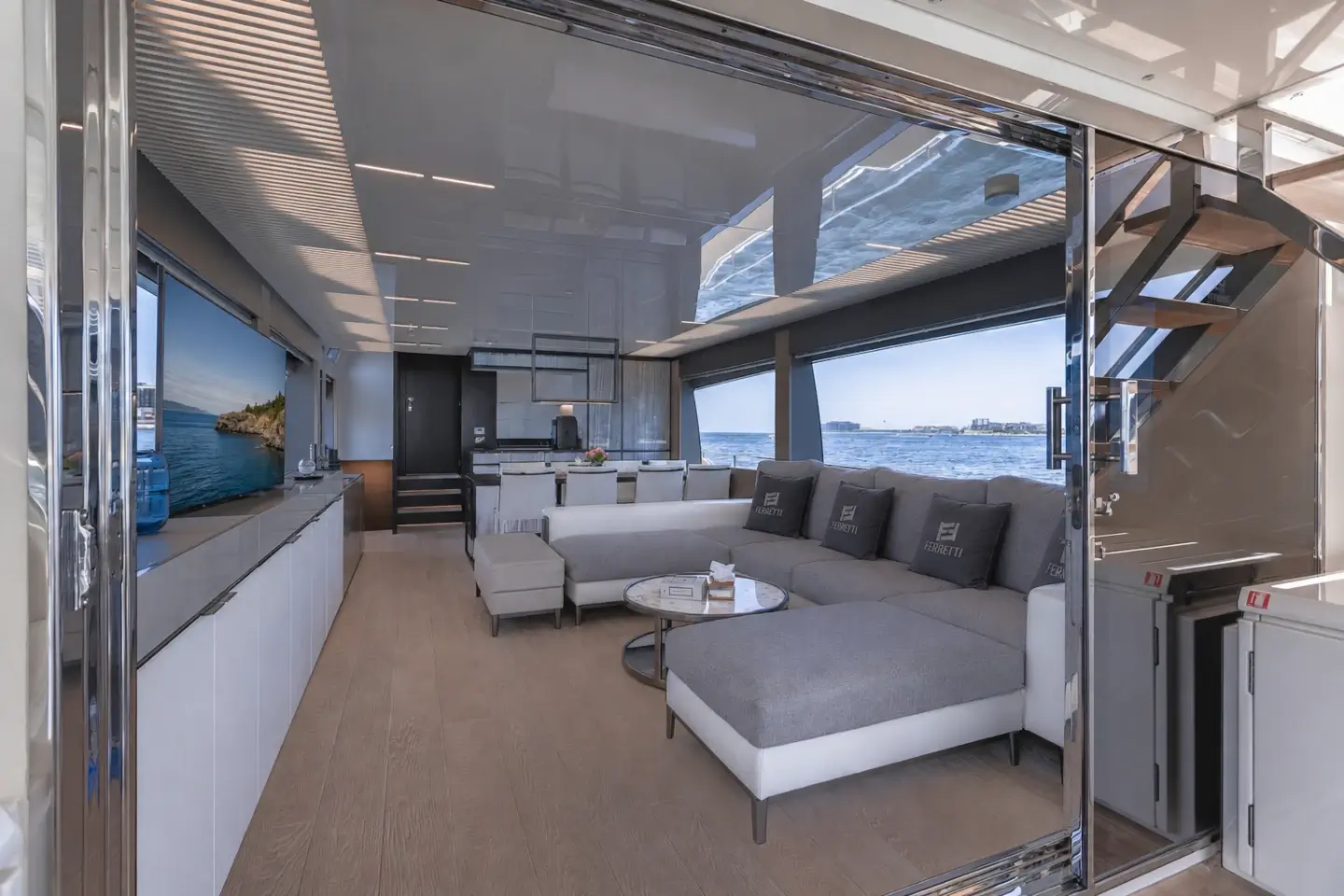 Ferretti 780 main saloon with corner sofa and full-height windows
