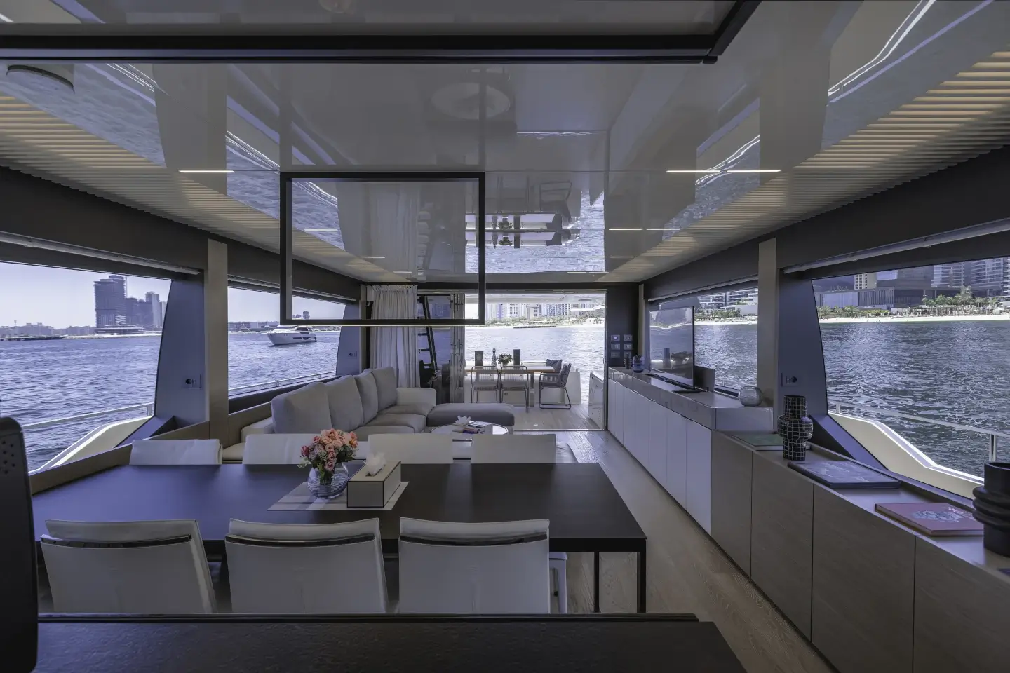 Ferretti 780 saloon looking aft to the dining table and cockpit doors