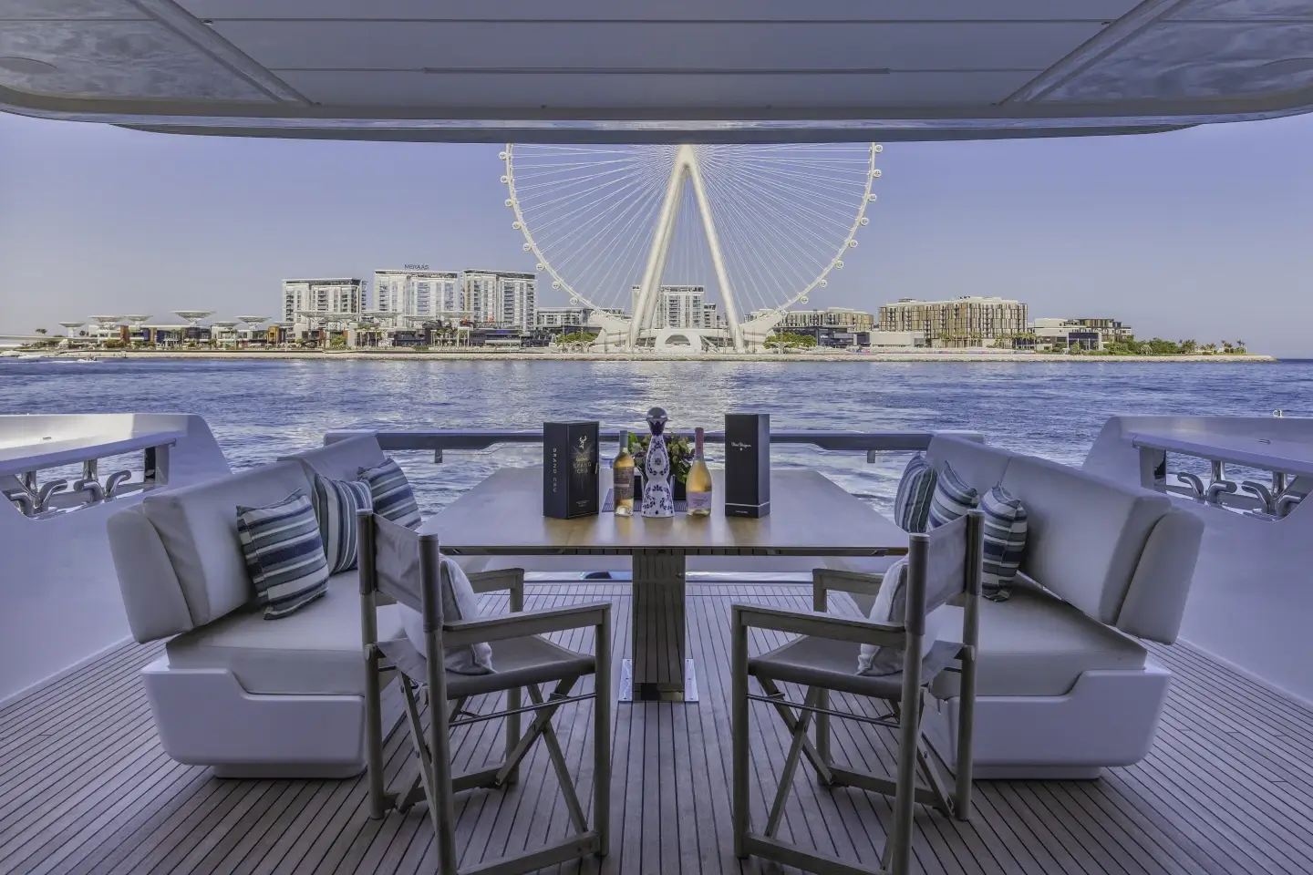 Ferretti 860 shaded aft cockpit dining set with Ain Dubai view