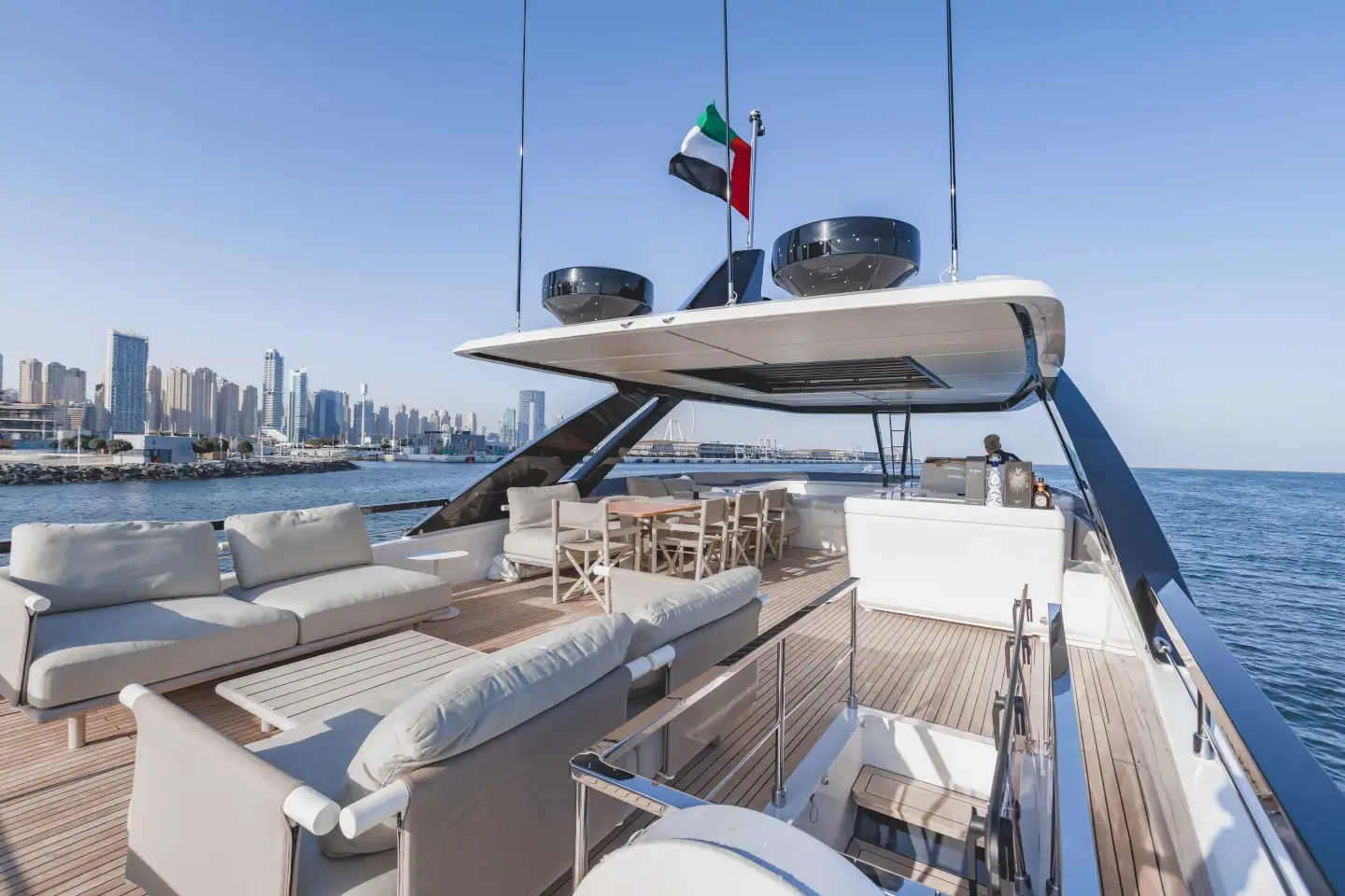 Ferretti 860 flybridge aft lounge with sun pads and courtesy flag