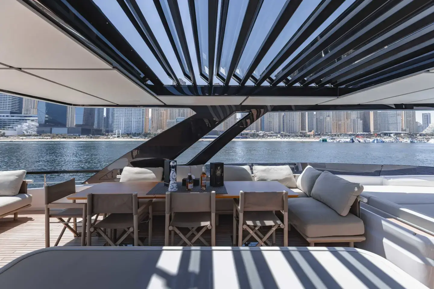 Ferretti 860 flybridge dining area beneath the shade louvres