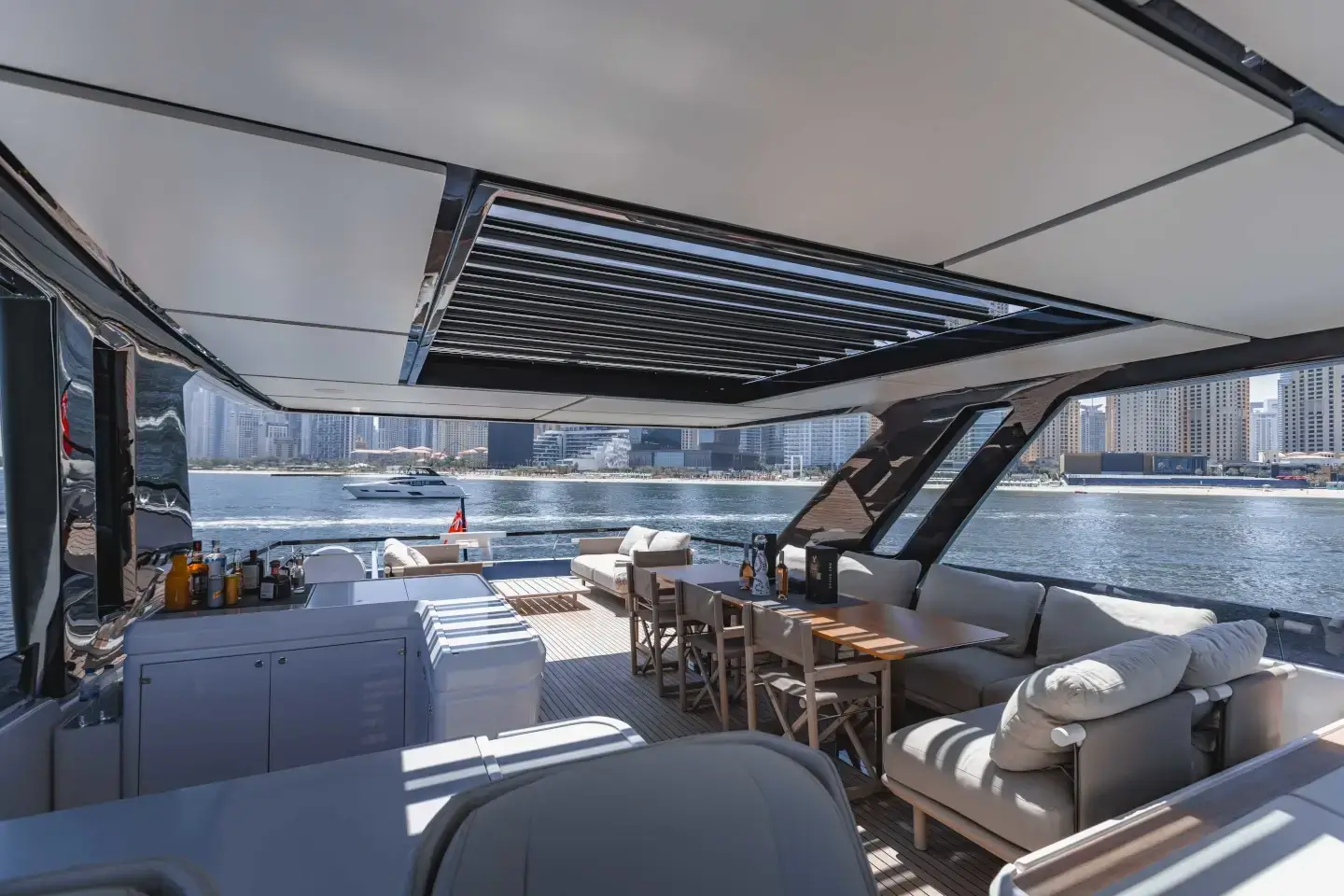 Ferretti 860 covered flybridge lounge seen from the cockpit stairs