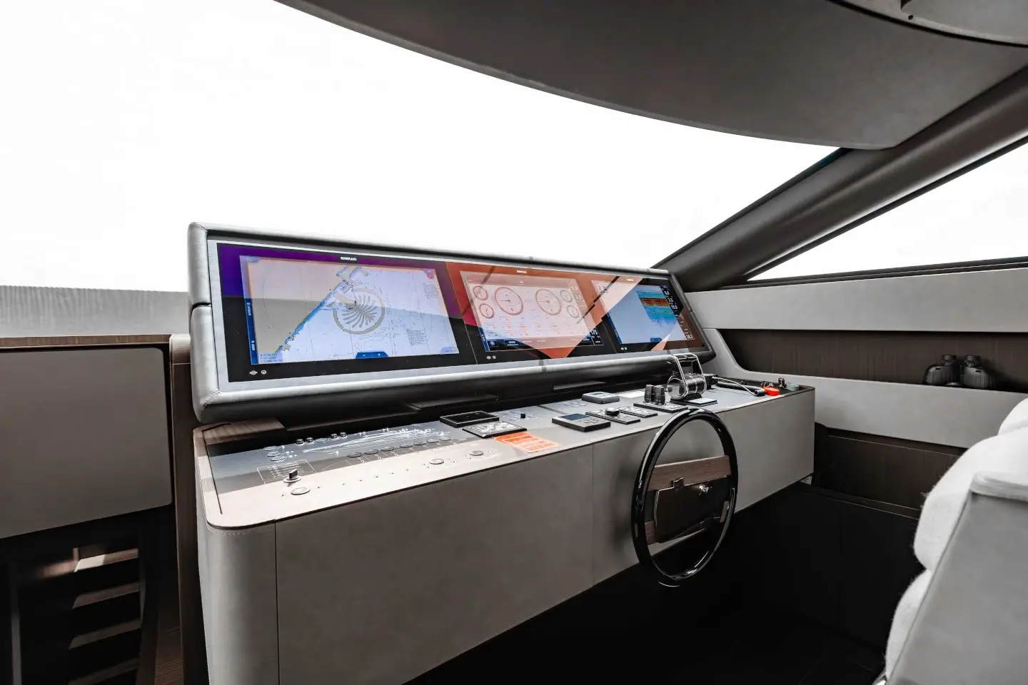 Ferretti 860 lower helm station with wraparound windscreen and displays