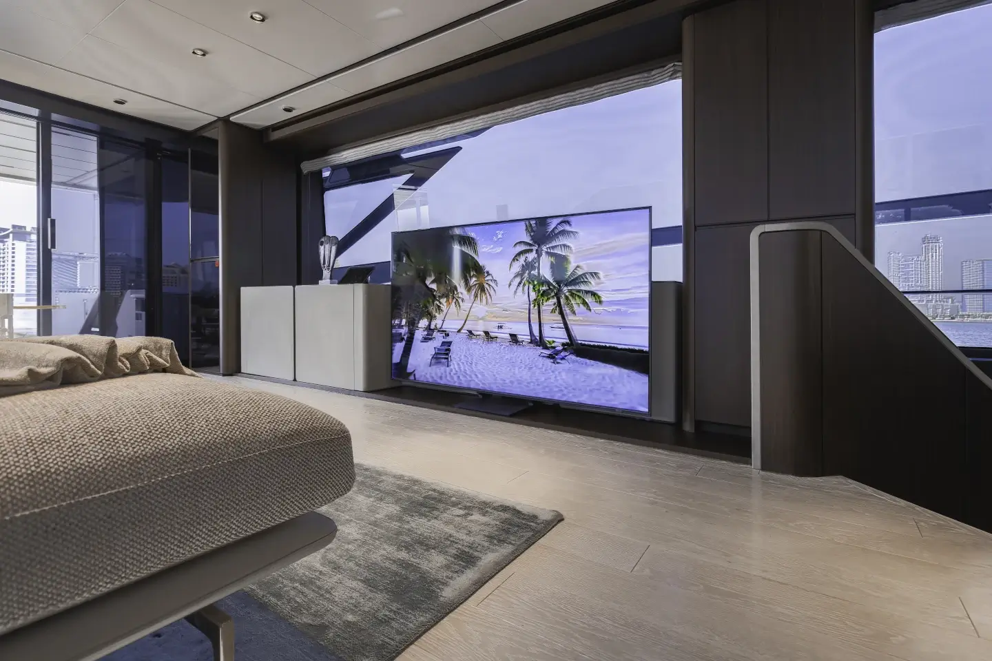 Ferretti 860 lounge with large flatscreen television and rug