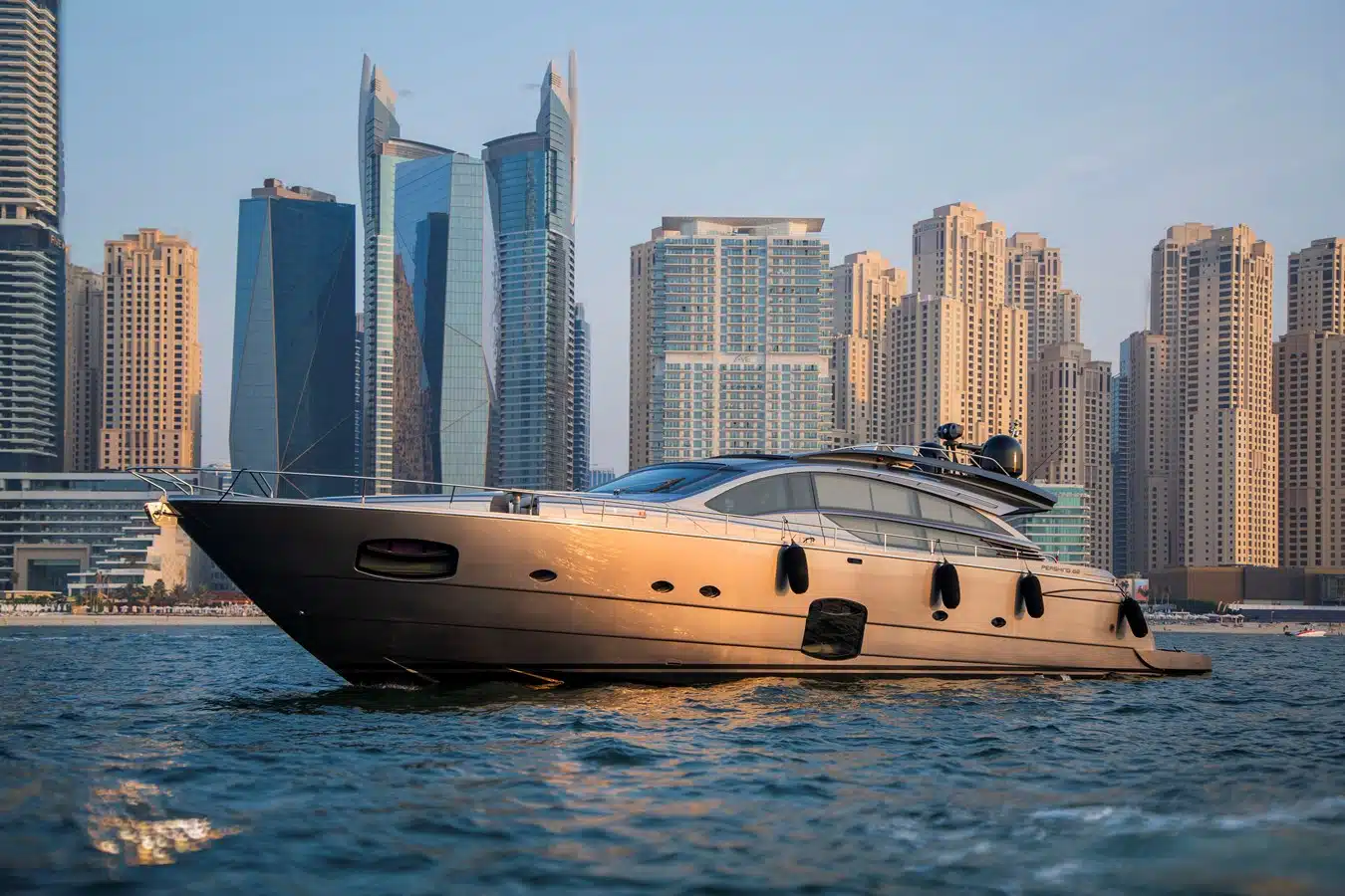 Motor yacht at anchor in Dubai Marina at golden hour