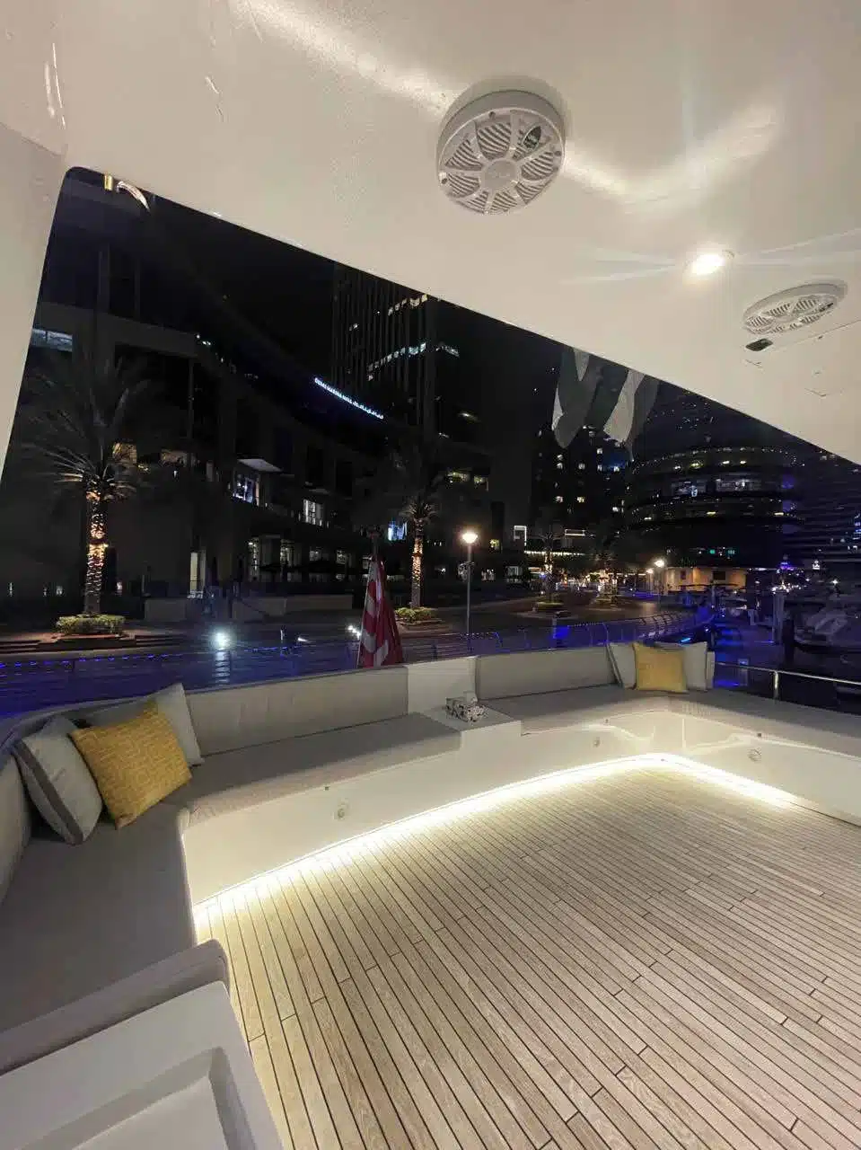 Vivir yacht deck lit up at night in Dubai Marina