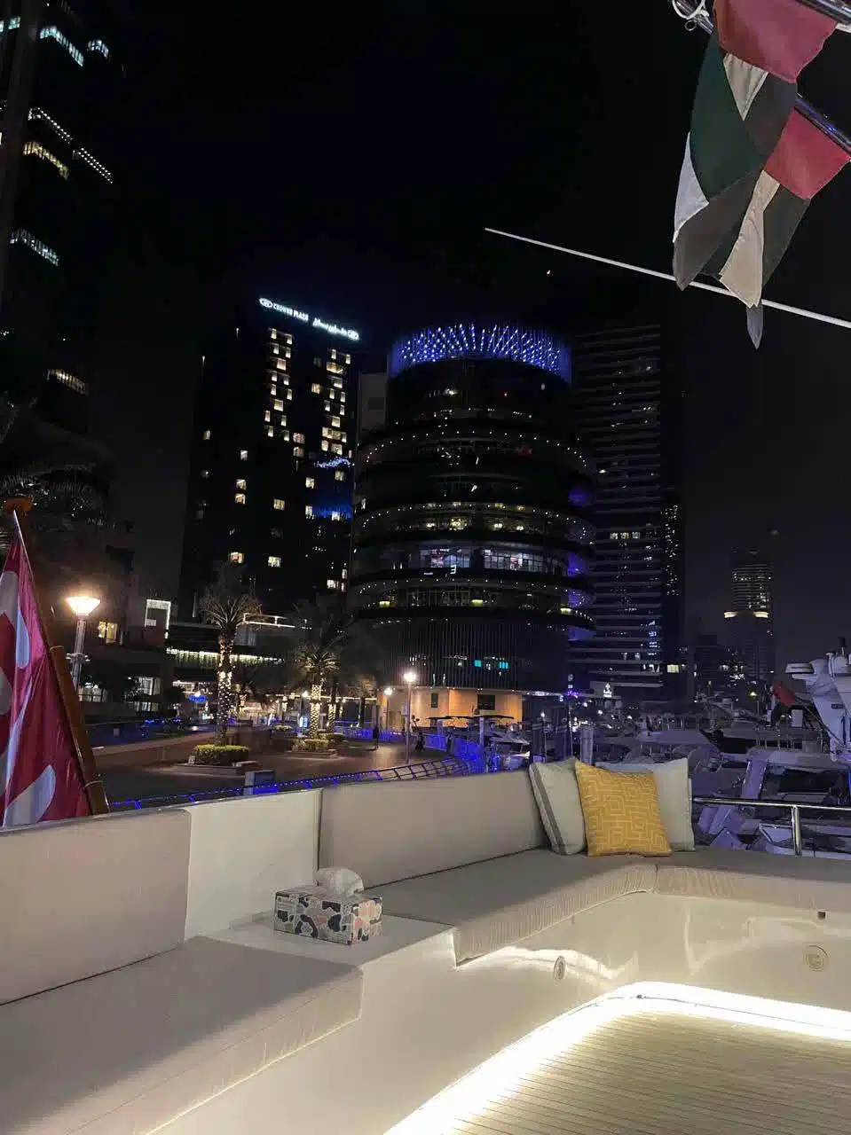 Vivir yacht deck lit up at night in Dubai Marina