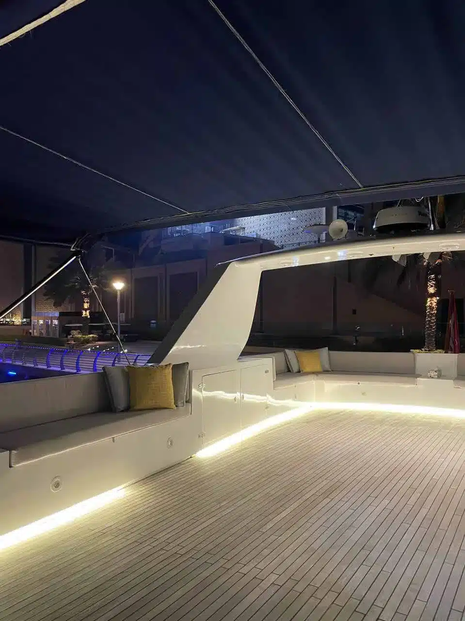 Vivir yacht deck lit up at night in Dubai Marina