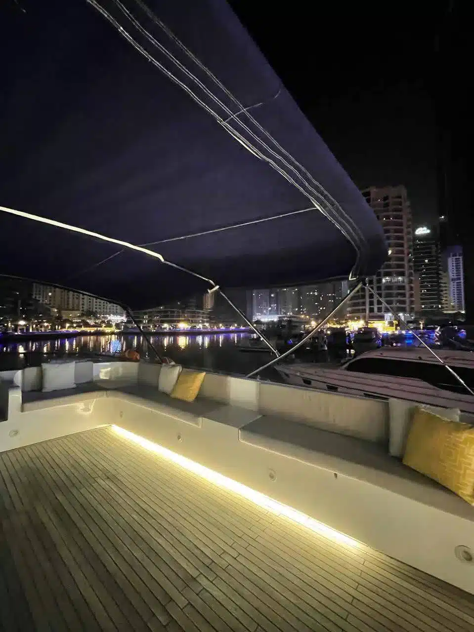 Vivir yacht deck lit up at night in Dubai Marina