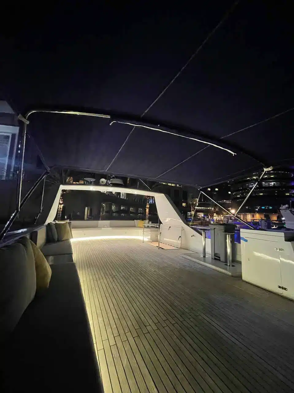 Vivir yacht deck lit up at night in Dubai Marina