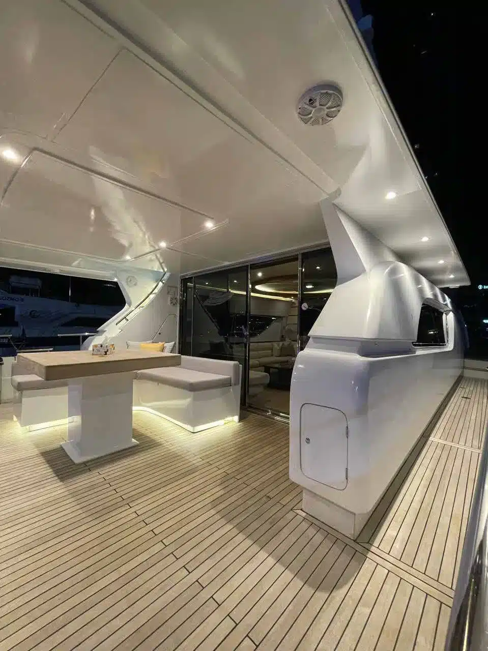 Vivir yacht deck lit up at night in Dubai Marina