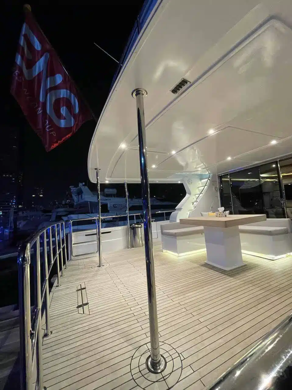 Vivir yacht deck lit up at night in Dubai Marina