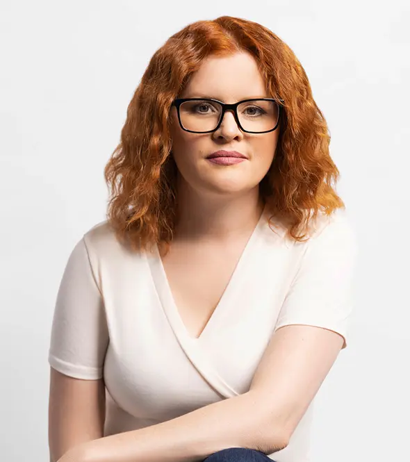 Rachel Gonzales appears in a professional studio portrait with glasses, highlighting her role in operations, systems, and client experience at Building Blocks Digital.