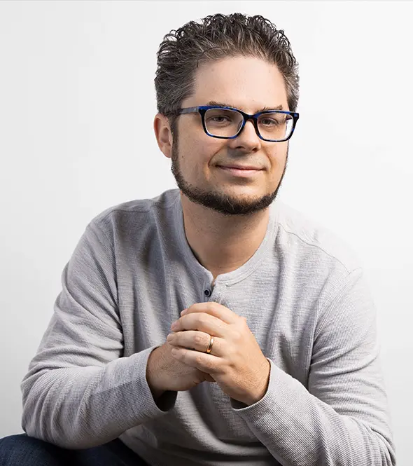 Avram Gonzales poses in a clean studio headshot, highlighting his role as Chief Strategist focused on HVAC and plumbing marketing strategy at Building Blocks Digital.