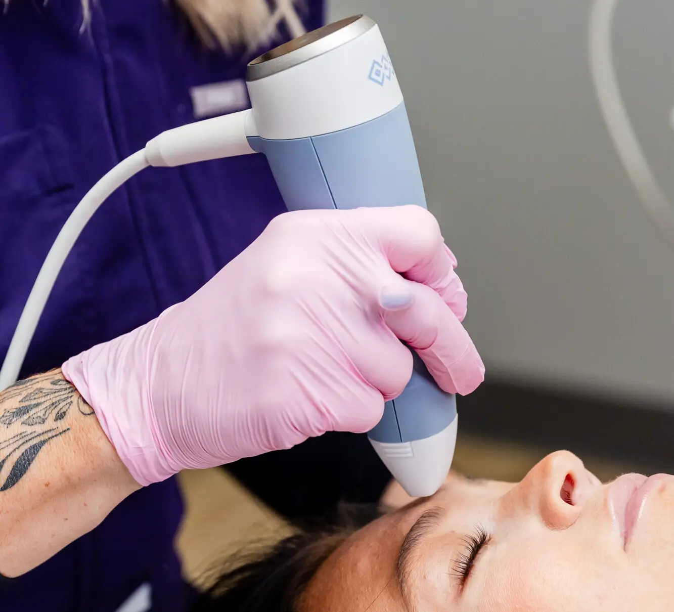 A patient shuts her eyes and relaxes while receiving a treatment for facial aesthetics in Columbus, OH.