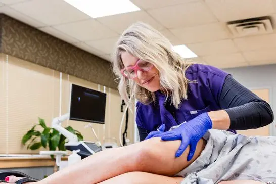 A shot of a vein specialist near Dublin, OH, performing a vein treatment
