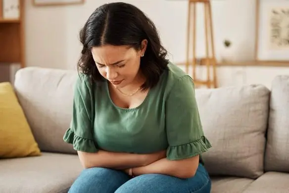 Stress,,Stomach,Pain,And,Woman,On,A,Sofa,With,Menstruation,