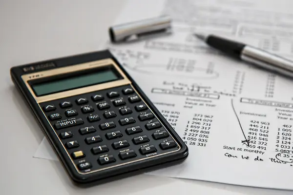 bills and calculator to symbolize repairing finances post-divorce