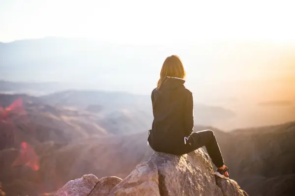 woman on mountaintop symbolizing retirement
