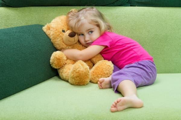 child hugging teddy bear to symbolize child custody