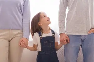 a picture that shows that the goal of child custody agreements is to foster a positive relationship between a child and both parents