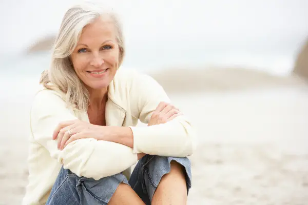 older woman sitting on beach symbolizing senior divorce