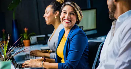 People on laptops for virtual payroll services