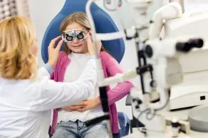 Girl at eye specialist controls vision